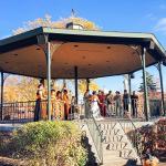 A group of people standing around a gazebo