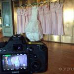 A camera taking a picture of a wedding dress