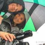 A man and a woman standing under an umbrella