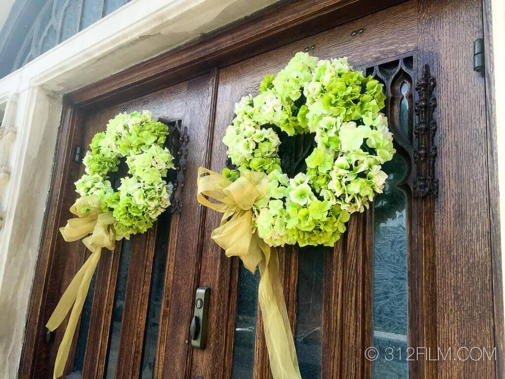 A couple of wreaths that are on a door