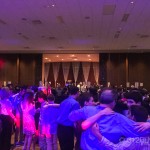 A group of people dancing in a large room