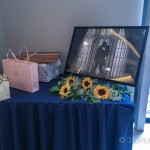 A table with flowers and a picture on it