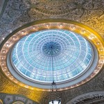 The ceiling of a large building with a glass dome