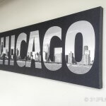 A black and white picture of chicago hanging on a wall
