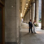 A bride and groom are walking down the street