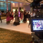 A video camera recording a group of people dancing