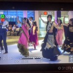 A group of people dancing on a tv screen