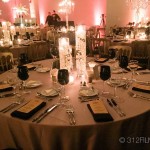 A table set for a formal dinner with candles and place settings