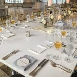 A table set for a formal dinner with wine glasses and silverware