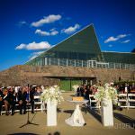 A wedding ceremony in front of a large building