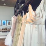 A bunch of dresses hanging on a rack