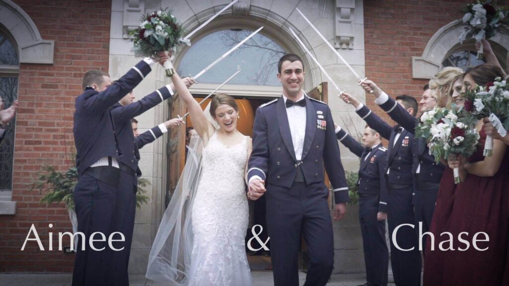 After the wedding ceremony at Lake Forest Wedding, the bride and groom pass under an honourary arch of sabres. 