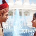 Indian man and a woman standing next to each other in front of a fountain Baps Wedding