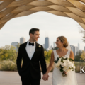 The bride and groom are standing under a honeycomb in Chicago's Lincoln Park, a famous spot for wedding videography.