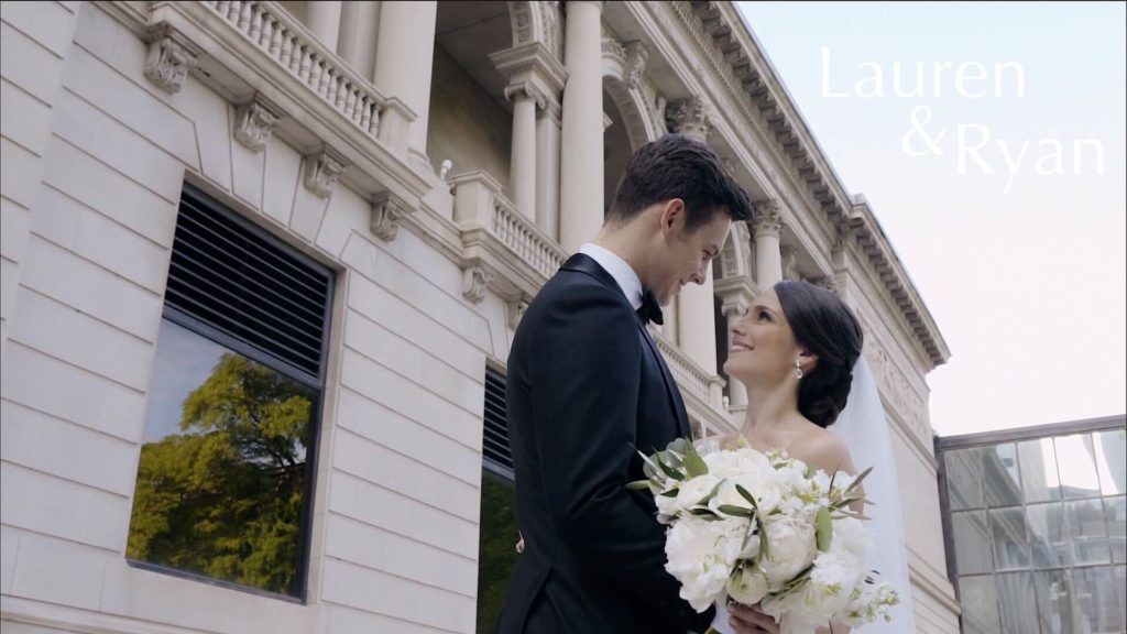 A couple is taking wedding photos in the South Garden of the Art Institute of Chicago, which is located in the city centre.