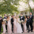 Gen and Ryan taking the wedding pictures with their wedding party at the Saddle & Cycle Club in Chicago