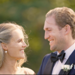 Bride & groom smile. Beautiful bow tie
