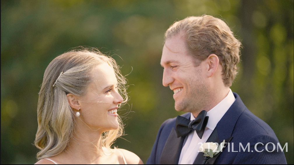 Bride & groom smile. Beautiful bow tie