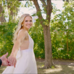 Bride takes groom hands and leads him