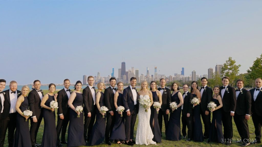 The bridal party is taking wedding photos before the reception at Theatre on the Lake in Chicago.