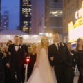 A bride and groom with their bridal party in the Chicago city Theatre