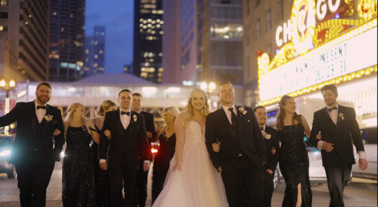 A bride and groom with their bridal party in the Chicago city Theatre