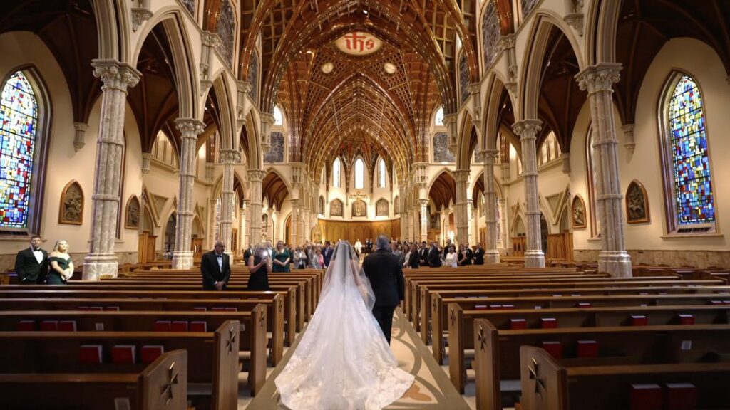 The bride walks down the aisle at Holy Name Cathedral in Chicago.