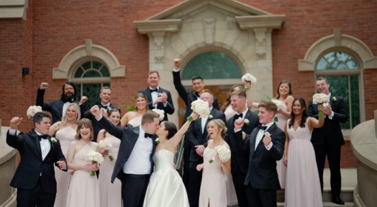 The bride and groom are outside the Church of St Mary in Lake Forest with their wedding party.