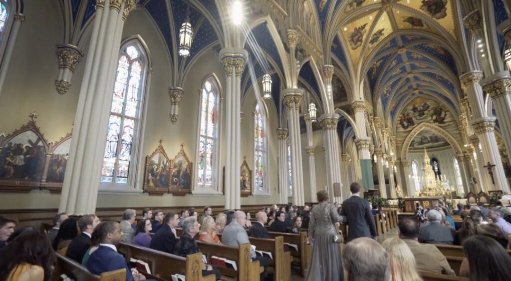 A guest walks down the aisle of the Basilica of the Sacred Heart at the University of Notre Dame. 