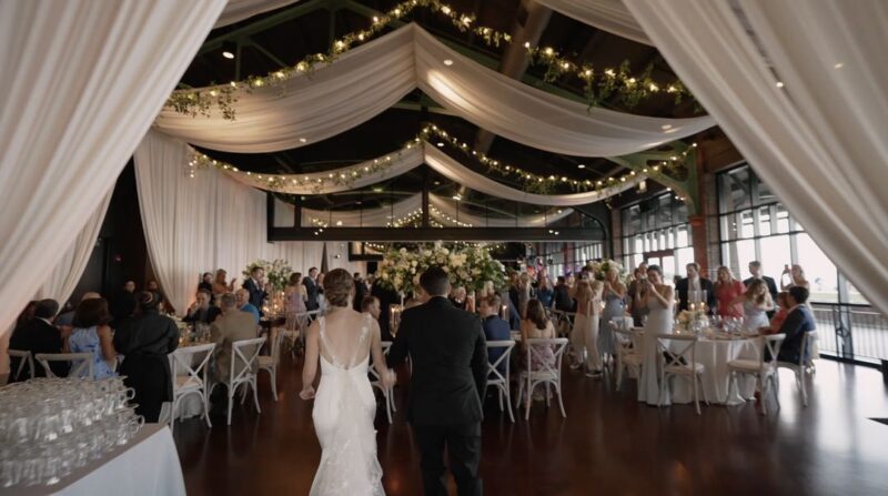 The wedding couple walk into the reception at the Theatre on the Lake in Chicago.