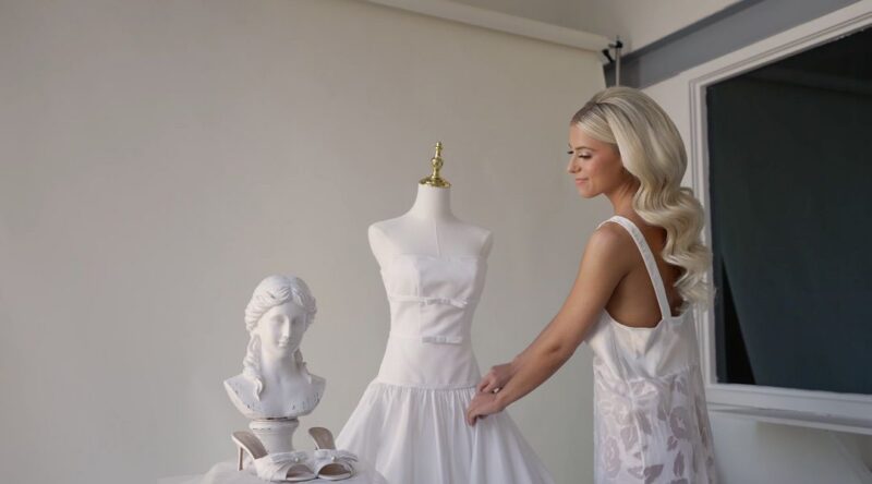 The bride checks her wedding dress in the morning.