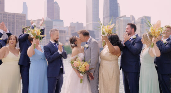The bride and groom with their bridal party at the iconic wedding photo spot in Chicago: Olive Park.