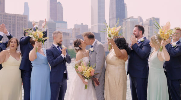 The bride and groom with their bridal party at the iconic wedding photo spot in Chicago: Olive Park.