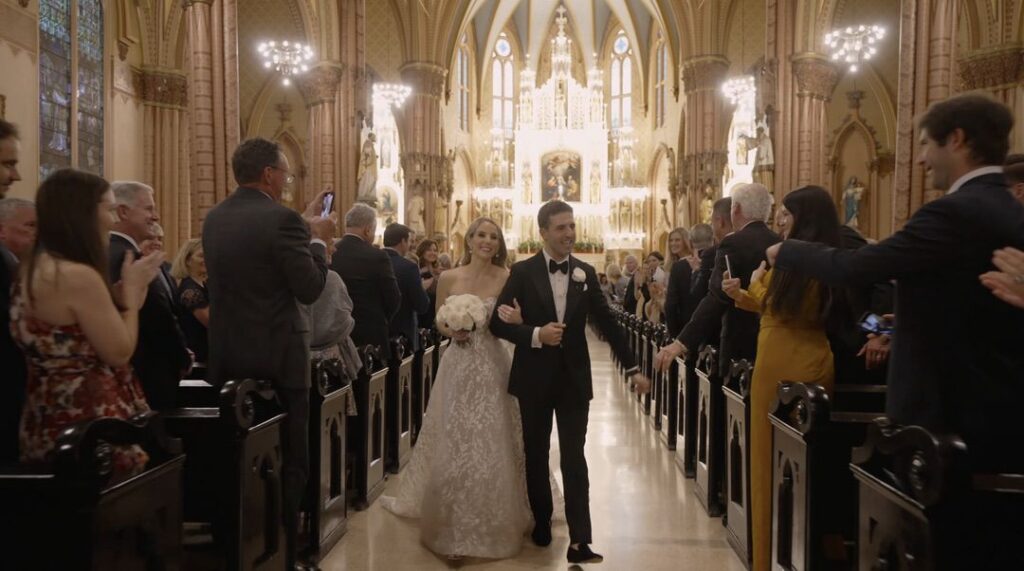 The bride and groom walk down the aisle after their ceremony at Holy Family Church in Chicago.