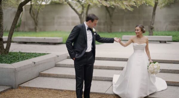 The bride and groom are taking their wedding photos in the South Garden of the Art Institute of Chicago.