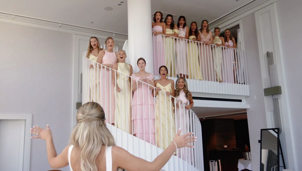 The bride reveals her wedding dress to the bridesmaids for the first time at The Ritz-Carlton, Chicago.