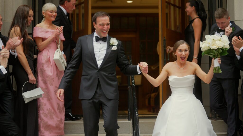 Kristen and Kyle leave St James in Chicago after their wedding ceremony.