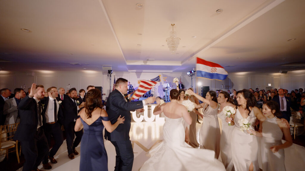 The bride and groom are entering the Hrvatska Svadba wedding at the Croatian Cultural Centre in Chicago.