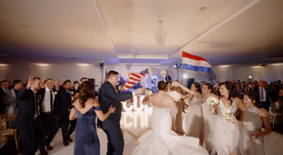 The bride and groom are entering the Hrvatska Svadba wedding at the Croatian Cultural Centre in Chicago.