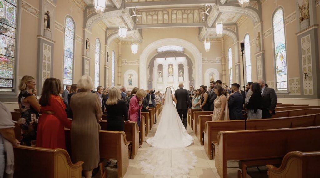 The bride walks down the aisle of Old St. Patrick's Church.