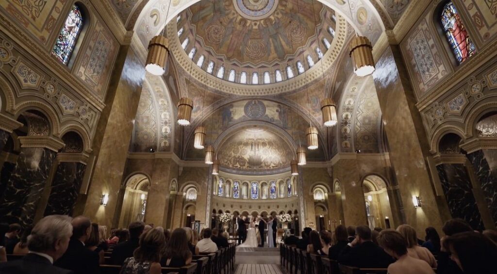 The bride and groom are getting married inside the Saint Clement Church in Chicago. 