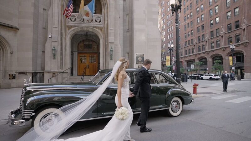The bride and groom are getting into a vintage car after their ceremony at St James's Chapel.