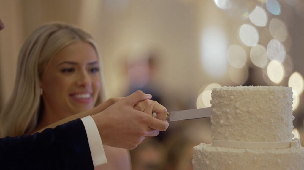 A couple cutting a cake made by Alliance Bakery at their wedding at TOPO. 
