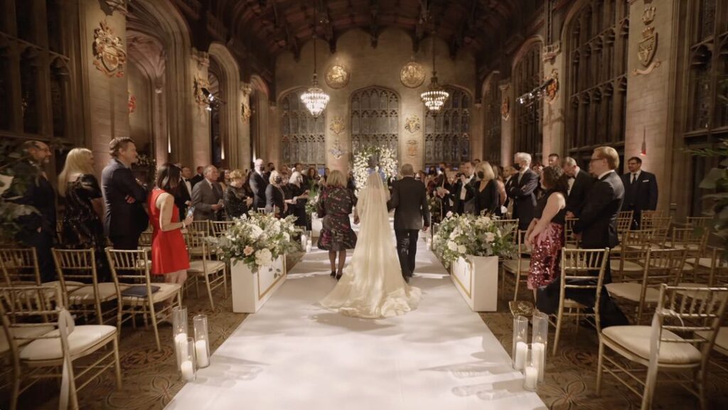 The bride walks down the aisle at the University Club of Chicago's Cathedral Hall.