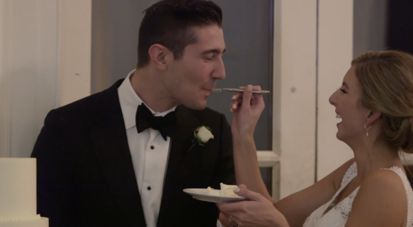 A couple are tasting their wedding cake during the reception at the Chicago History Museum.