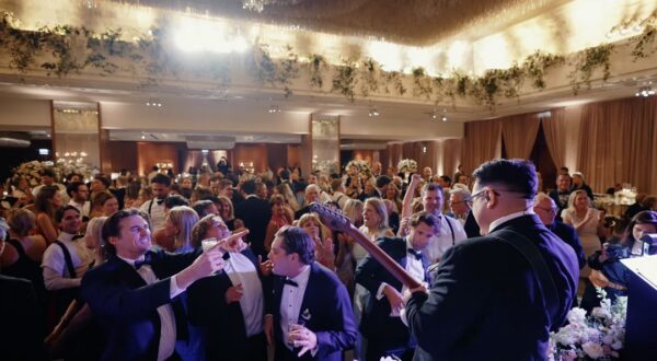 Wedding guests are enjoying dancing on the dance floor while the band is playing at the Ritz-Carlton, Chicago.