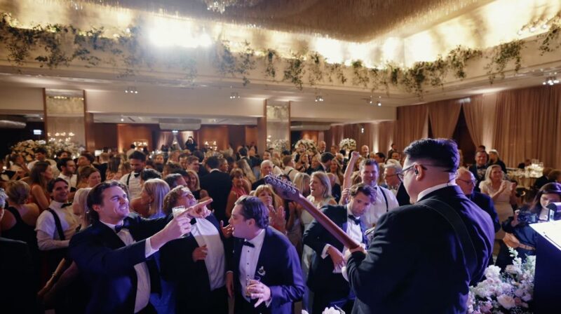 Wedding guests are enjoying dancing on the dance floor while the band is playing at the Ritz-Carlton, Chicago.