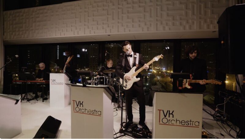 The groom playing on stage at the wedding.