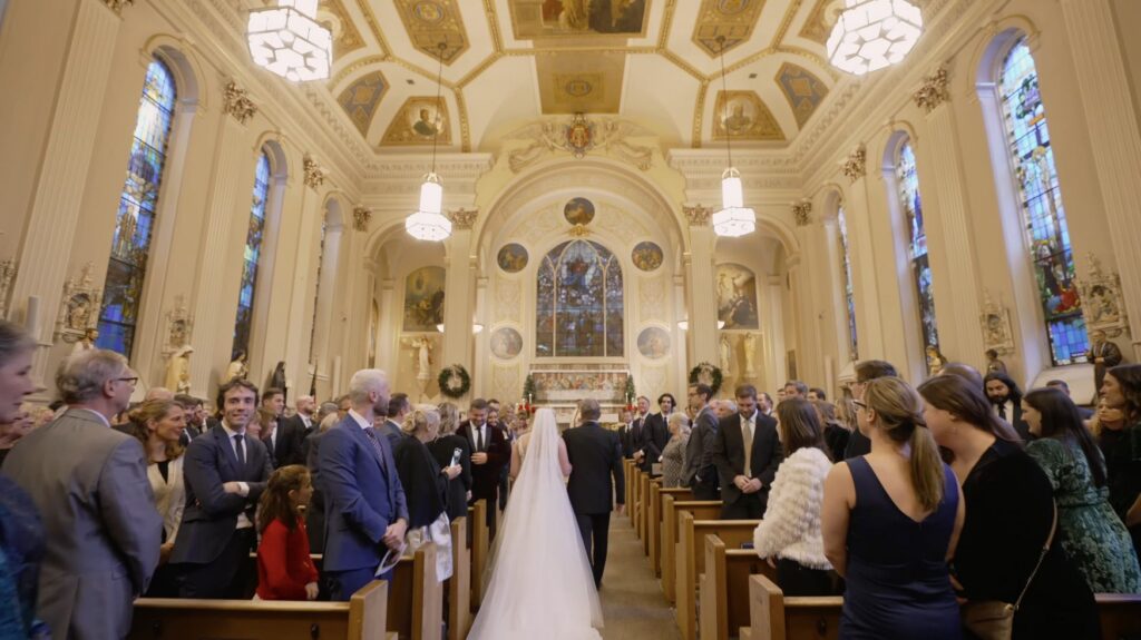 The bride walks down the aisle at Assumption Catholic Church in River North.