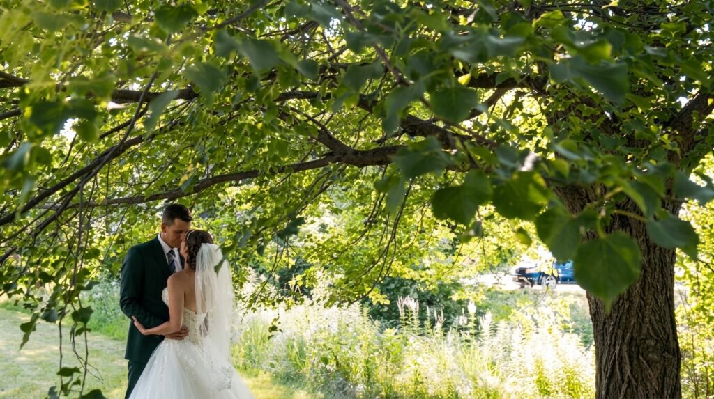 The bride and groom kiss under a tree after the ceremony at St Mary's Church in Buffalo Grove.